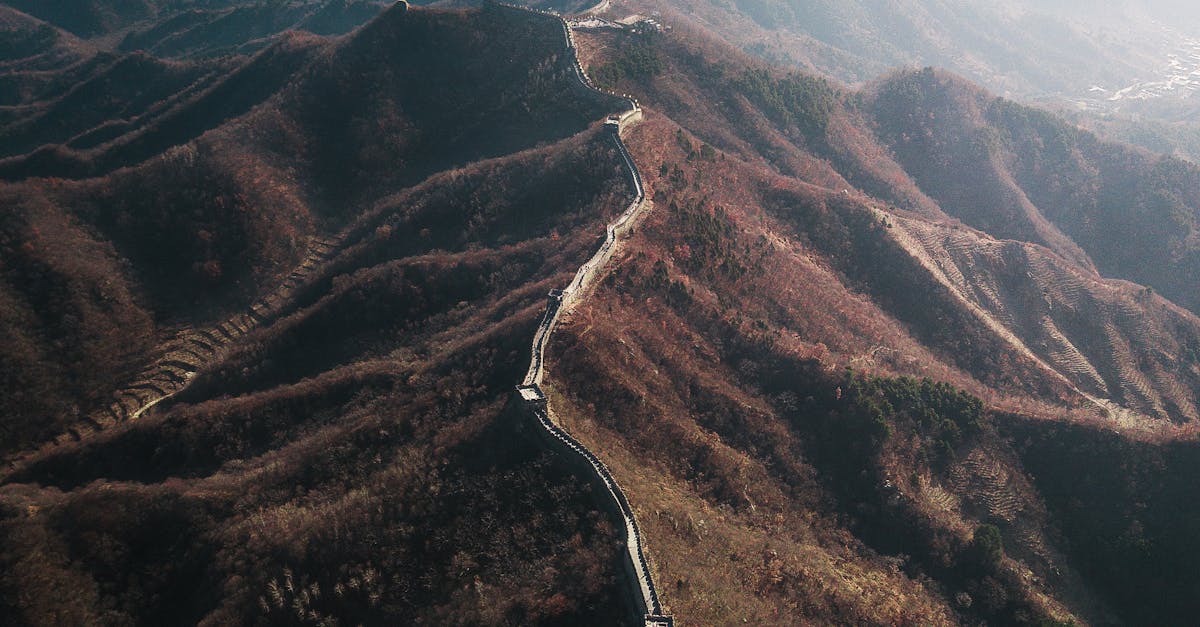 Stunning aerial shot of the Great Wall of China winding through mountains in autumn.