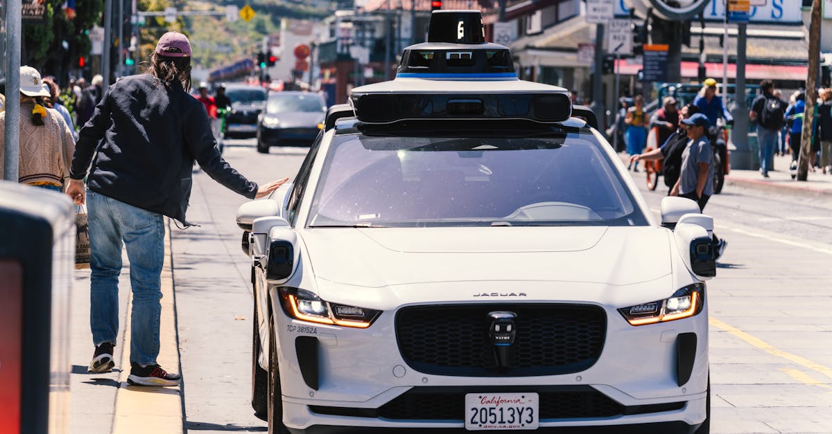 A self-driving car navigates through a bustling city street in San Francisco, capturing urban mobility in action.